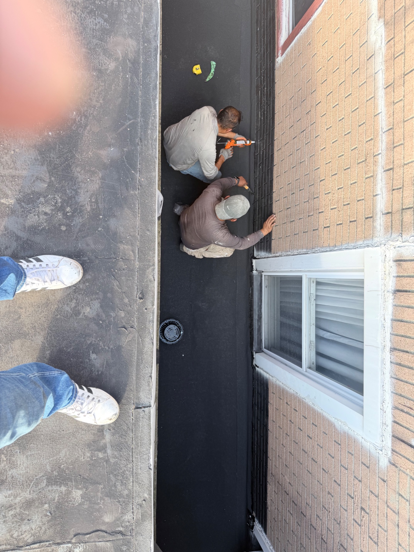 Crew fastening and sealing the new flat roof membrane