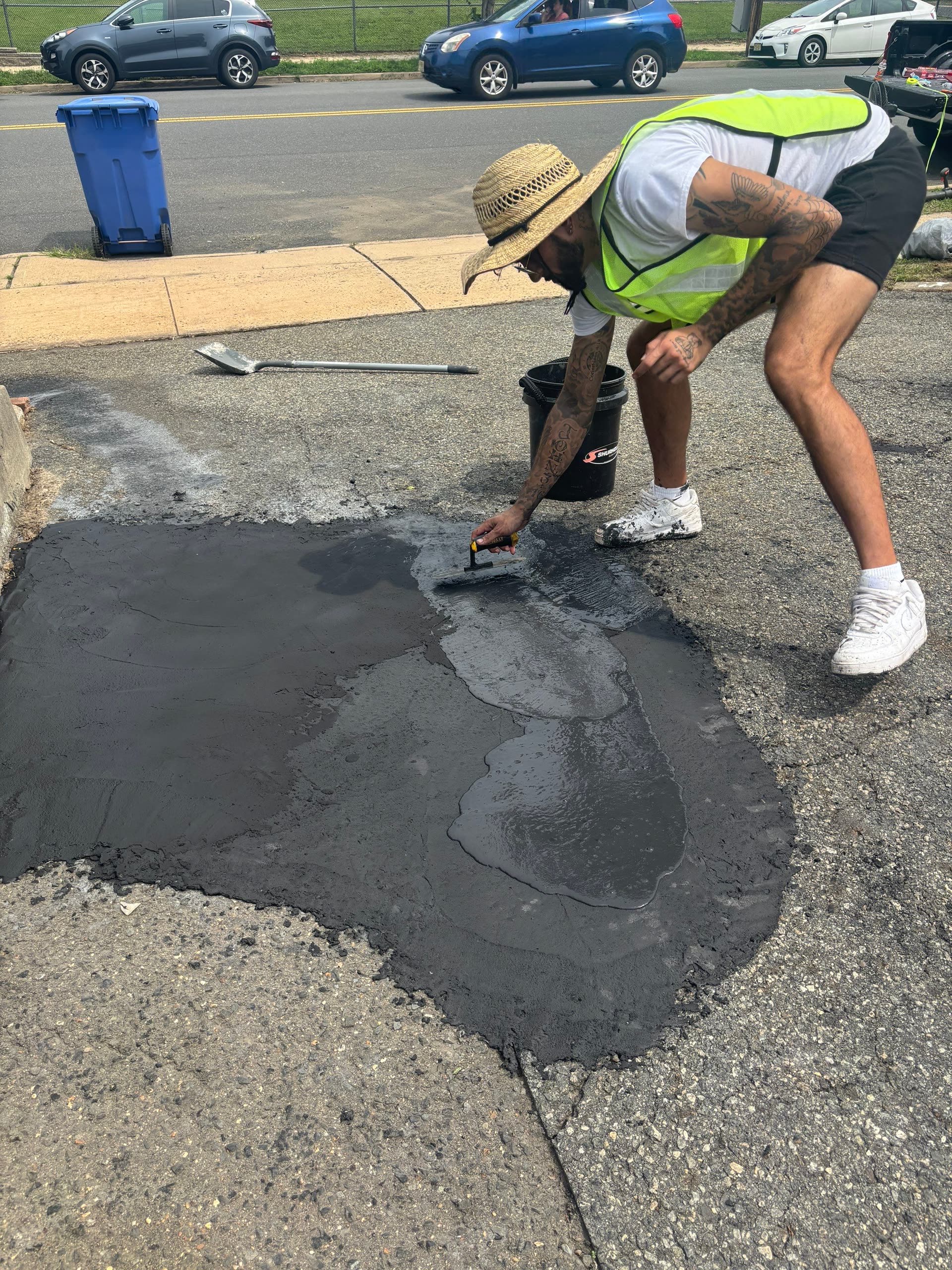 Sealcoating being applied to a repaired driveway