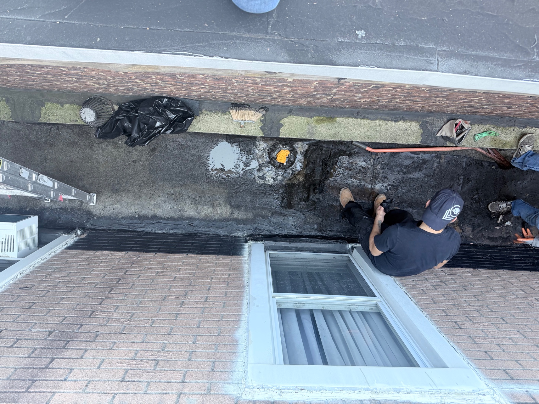 Crew preparing the flat roof and drain area